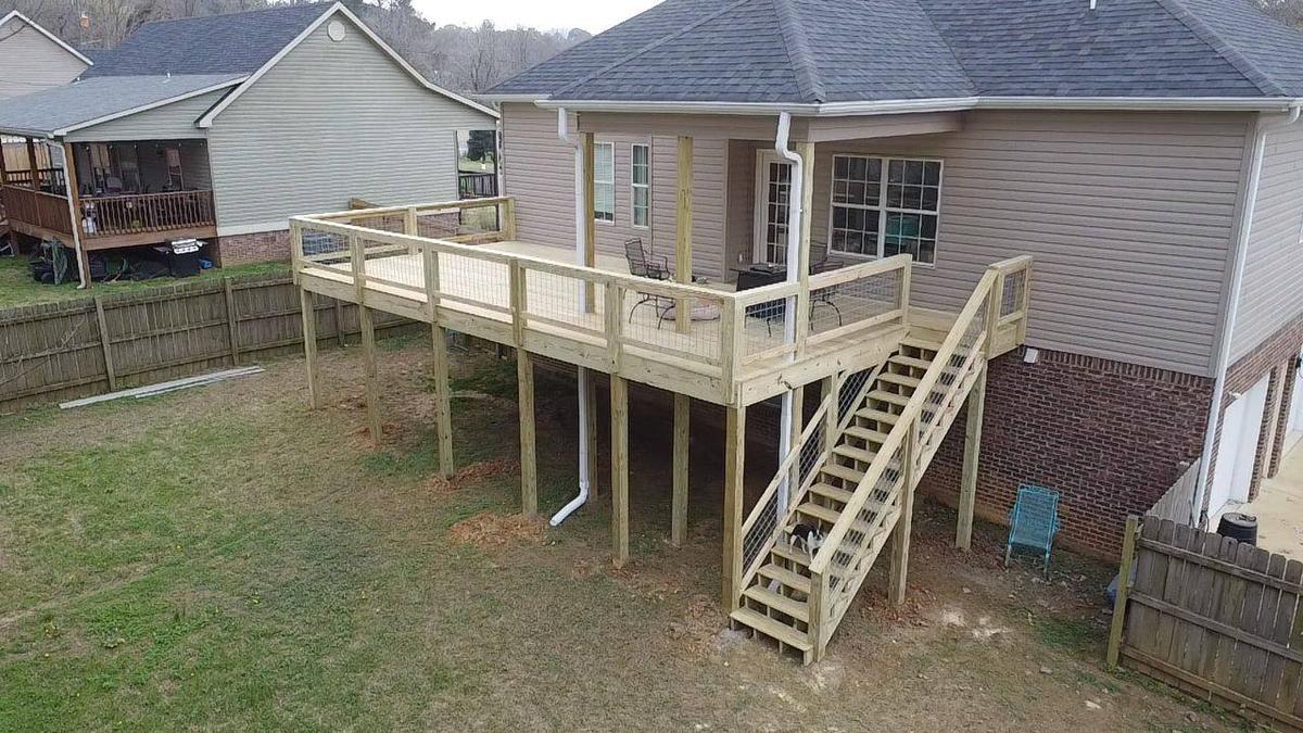 Wide deck with hog-wire railing built by Redbone Woodworks