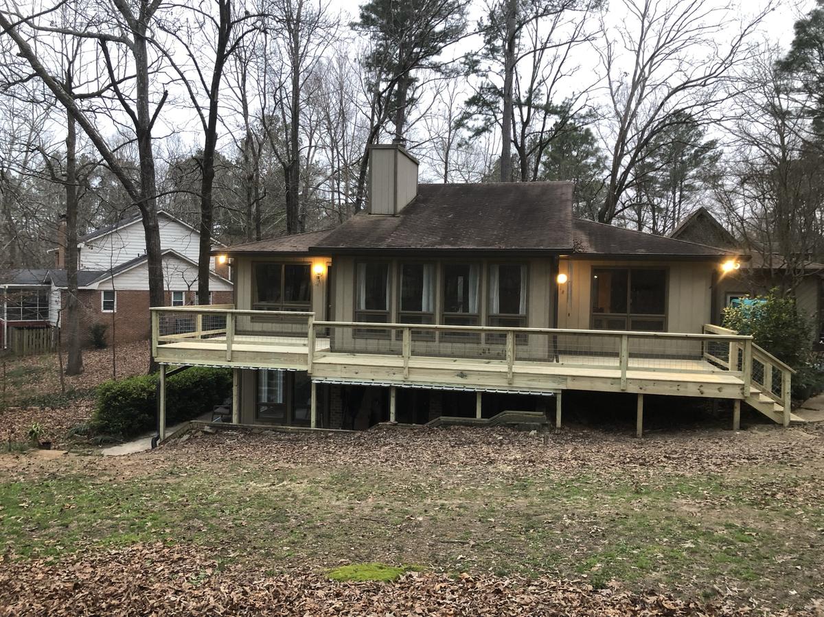 Finished deck with custom railing built by Redbone Woodworks