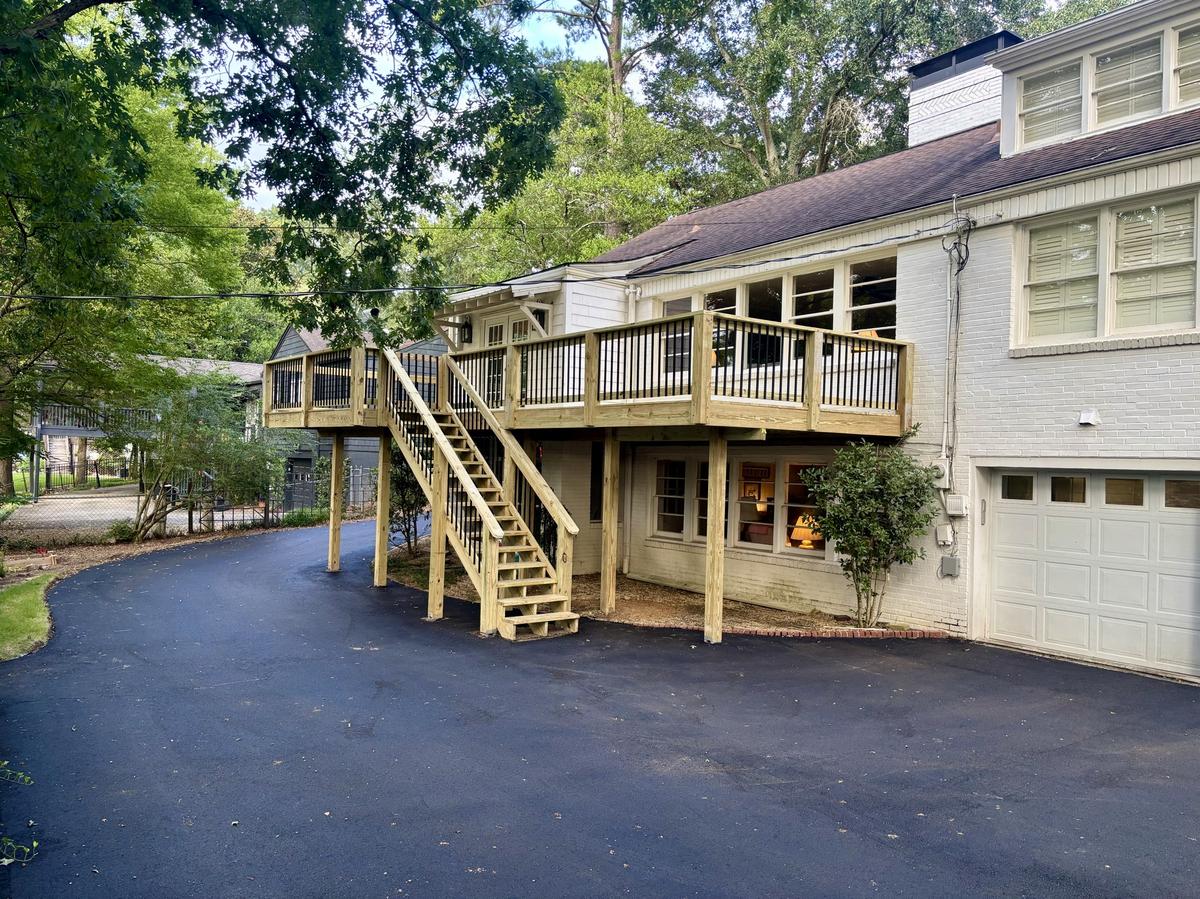 Elevated deck with long staircase built by Redbone Woodworks